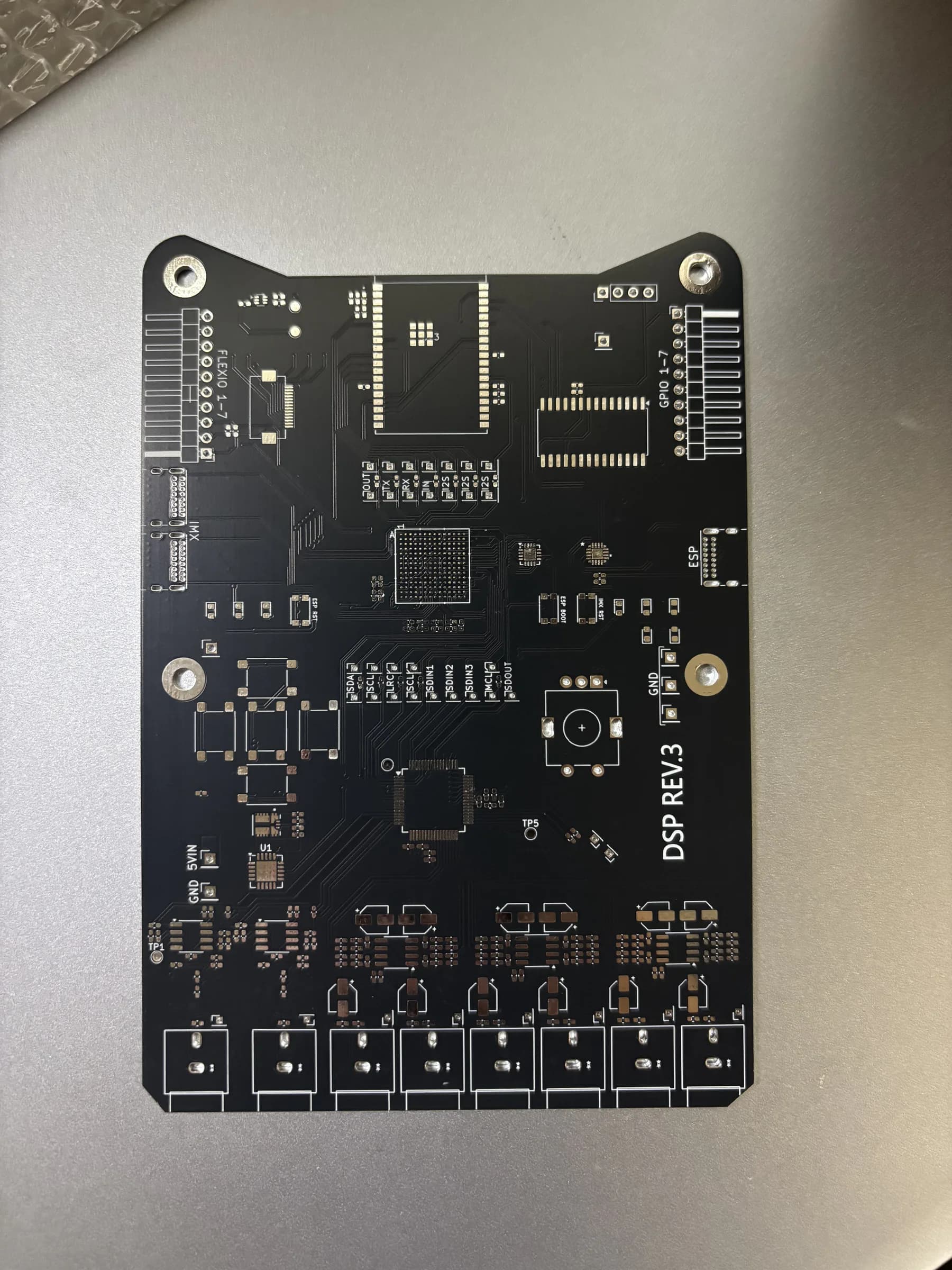 Front side of the fabricated black DSP Revision 3 PCB before assembly.