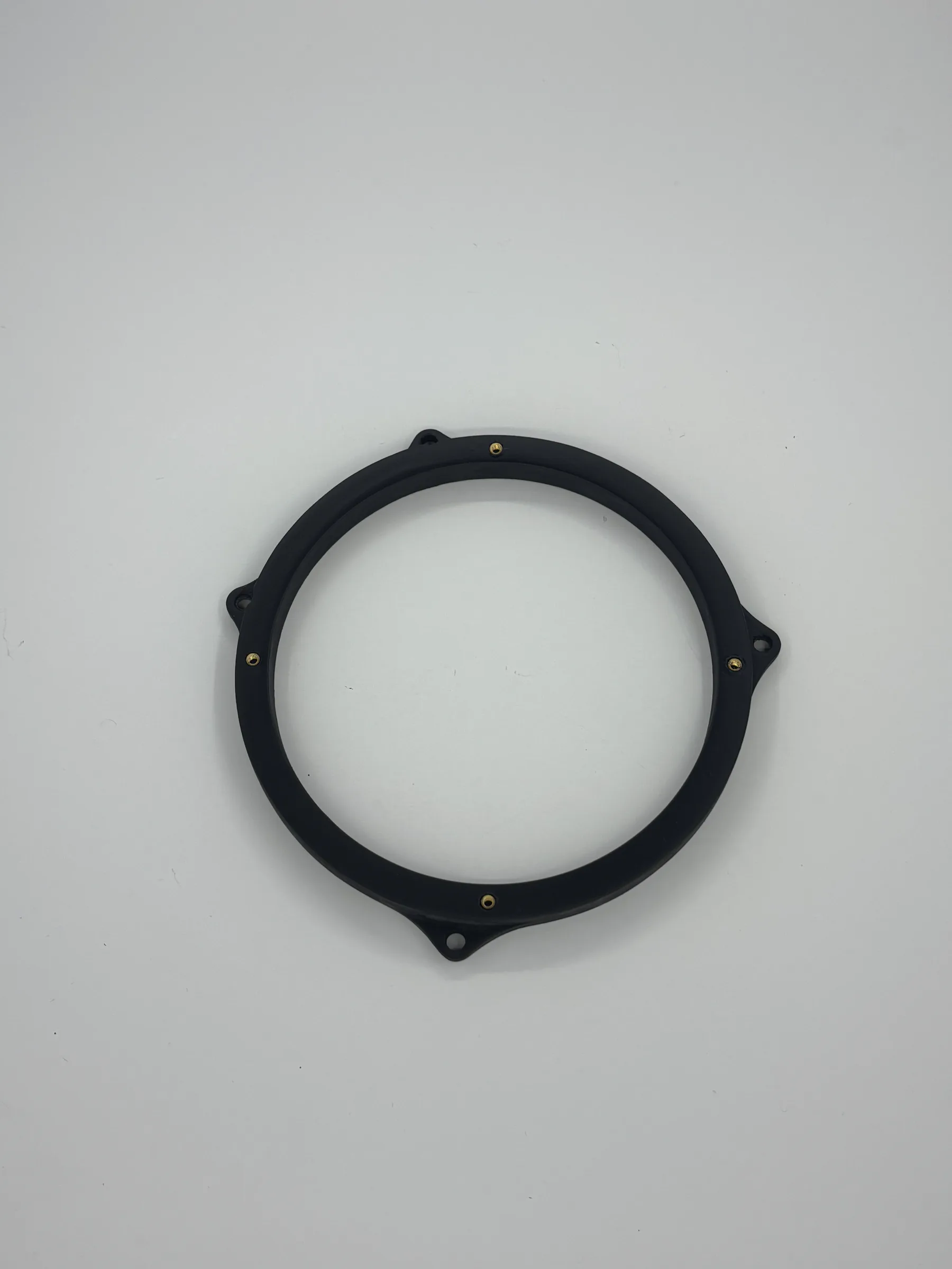 Finished matte-black 6.5-inch speaker adapter with four brass threaded inserts on a white surface.