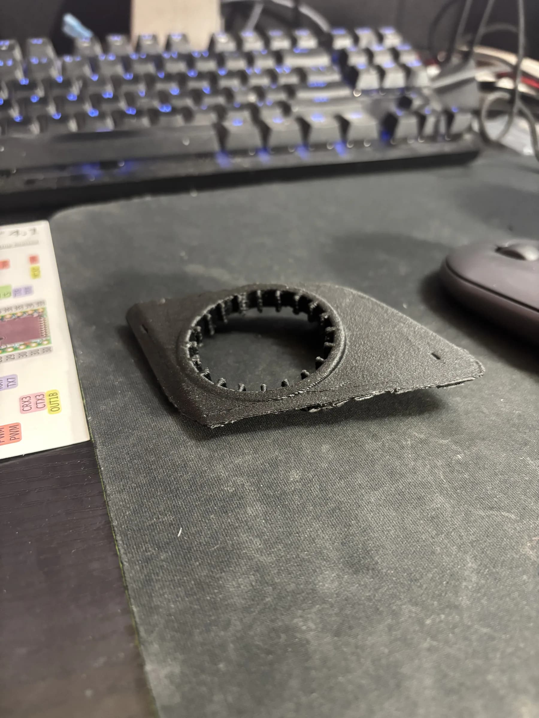 Black 3D-printed tweeter adapter revision on the workbench.