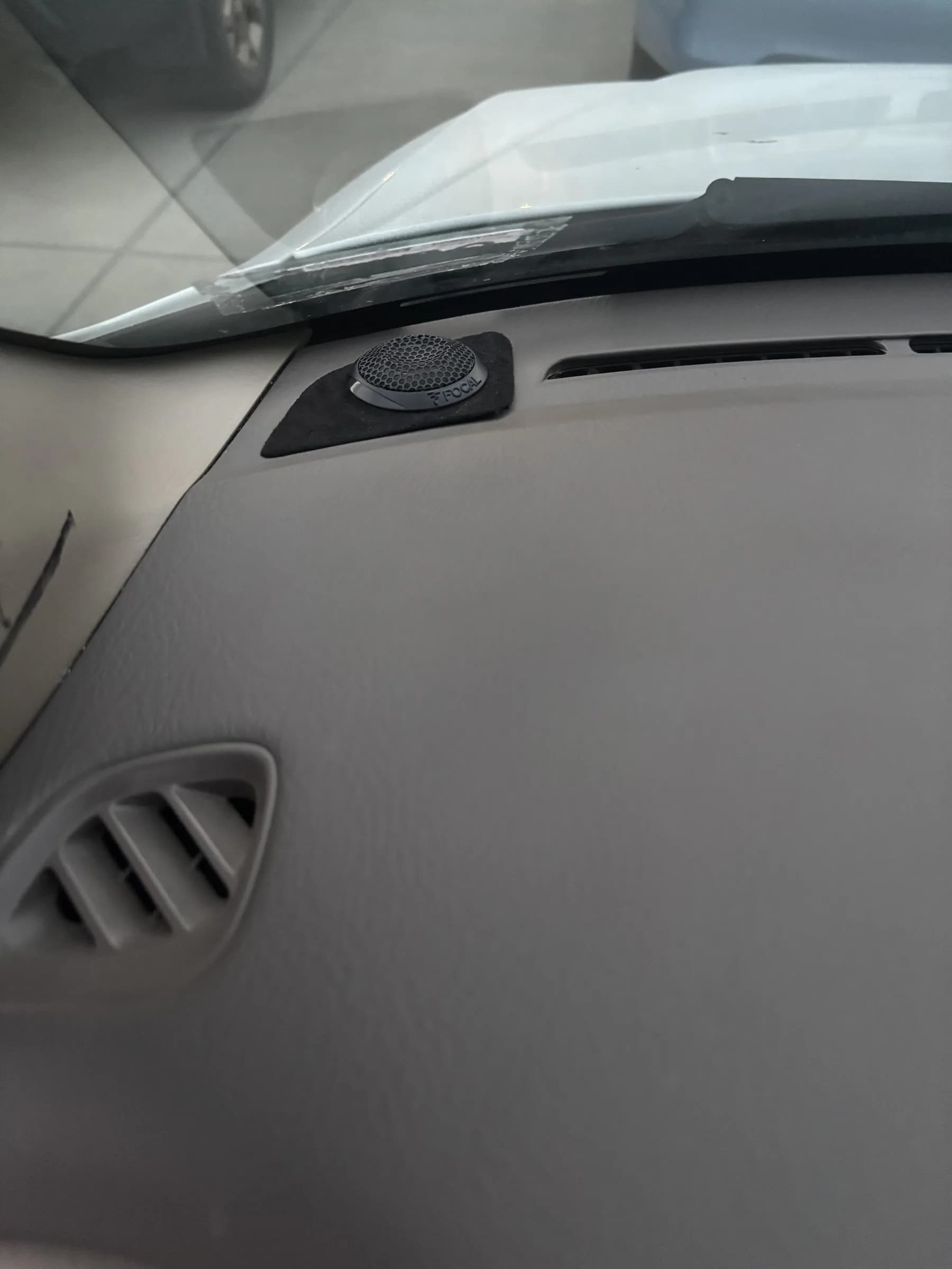 Tweeter installed flush in the factory Honda Accord dashboard pocket.